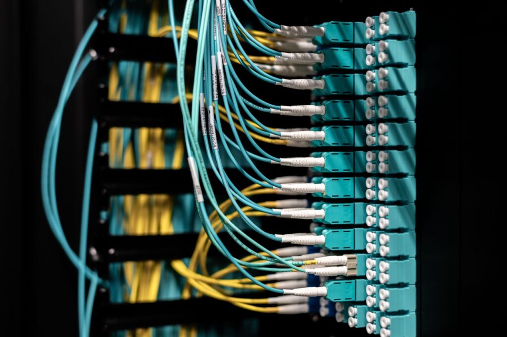 The Art of Drawing Readers In: Your attractive post title goes here Closeup of electronic device with colorful wires installed in rows in communications room on blurred background in dark studio inside