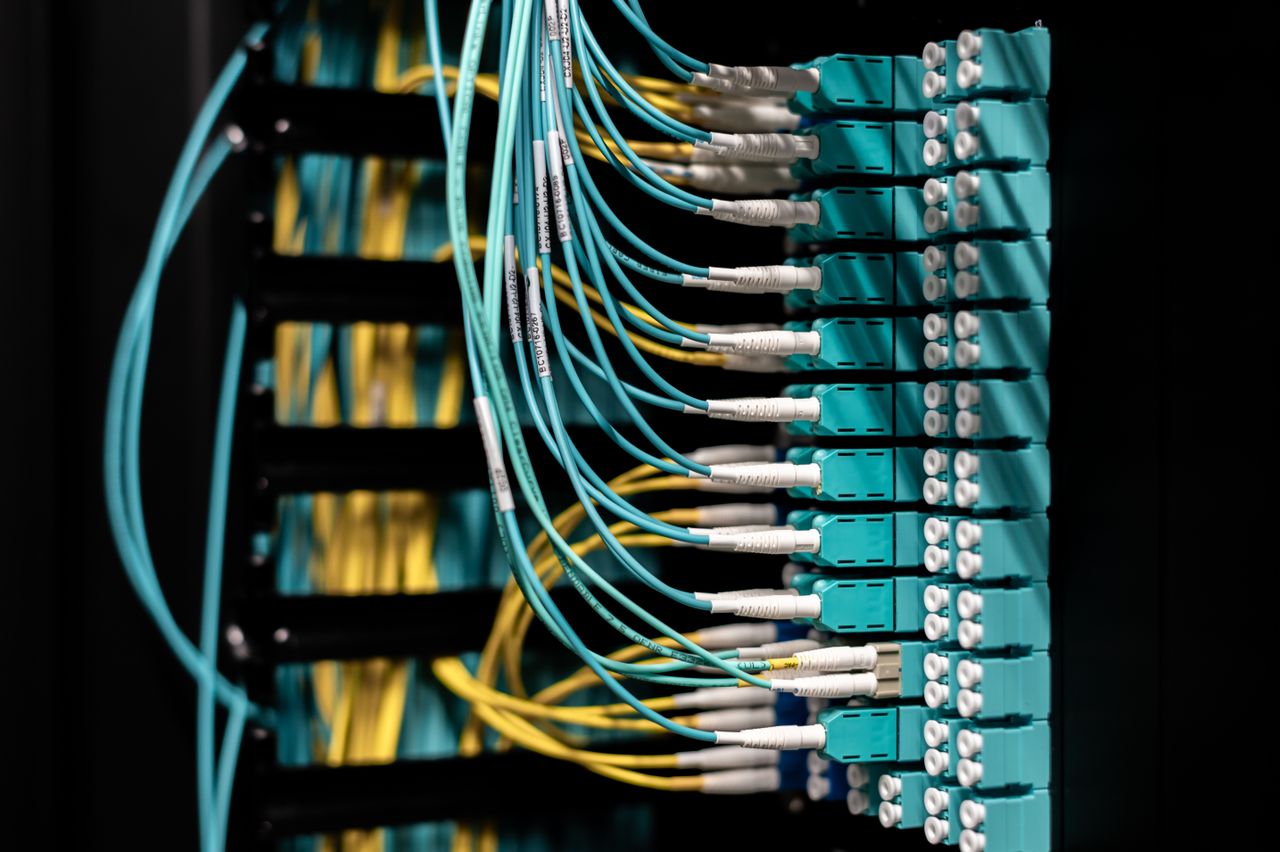 The Art of Drawing Readers In: Your attractive post title goes here Closeup of electronic device with colorful wires installed in rows in communications room on blurred background in dark studio inside